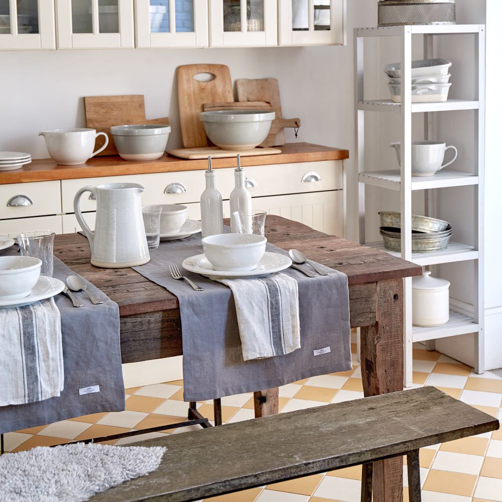 Casafina Fattoria medium mixing bowl displayed on a rustic wooden table set with tableware in a bright kitchen.
