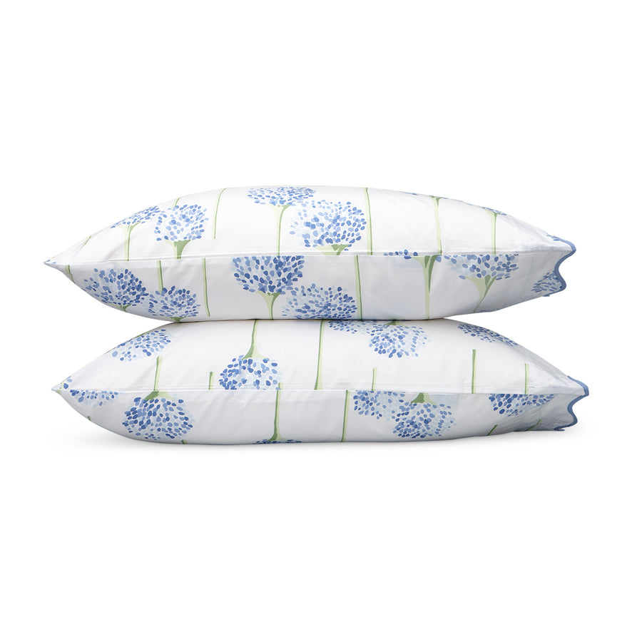 Matouk Charlotte Pillowcases featuring a floral design with blue flowers and green stems on a white background.