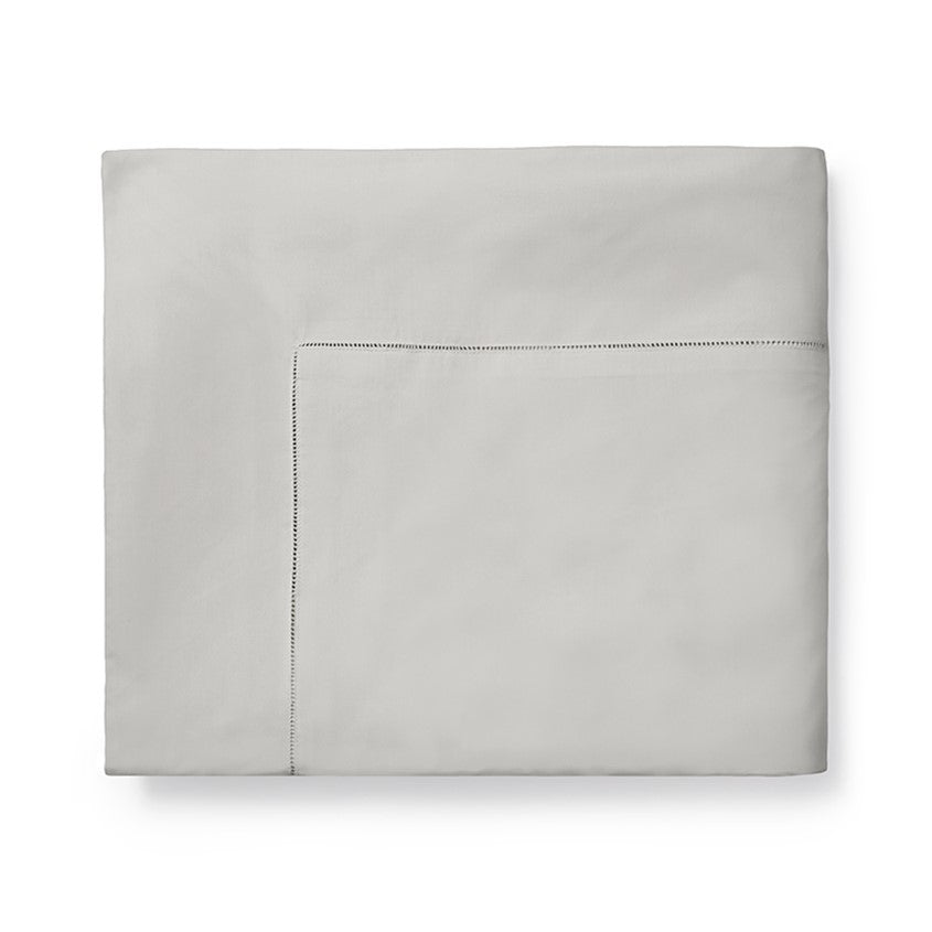 Sferra Celeste Duvet Cover in soft gray with elegant stitching detail, perfect for a sophisticated bedroom decor.