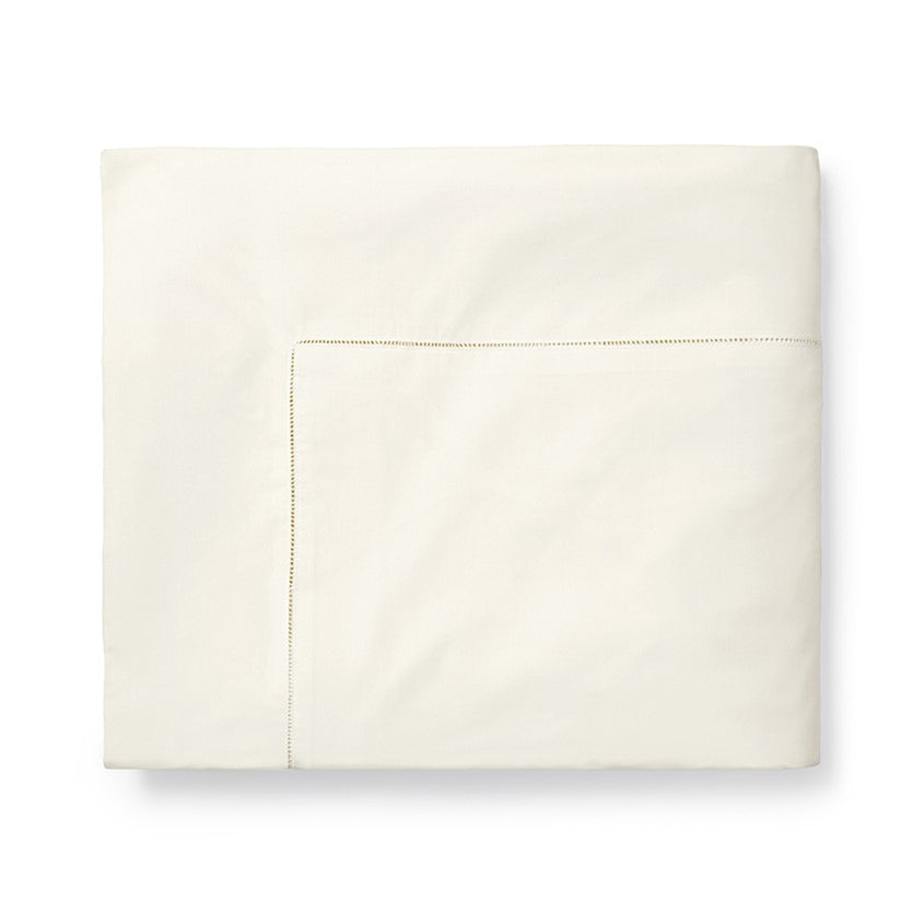 Sferra Celeste duvet cover in soft cream with subtle stitching detail, ideal for elegant bedroom decor.