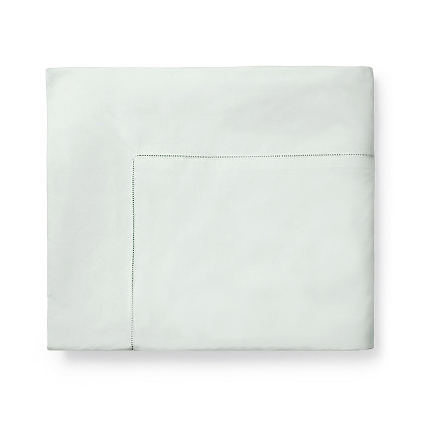 Sferra Celeste Duvet Cover in soft light green with delicate stitching detail along the edge.
