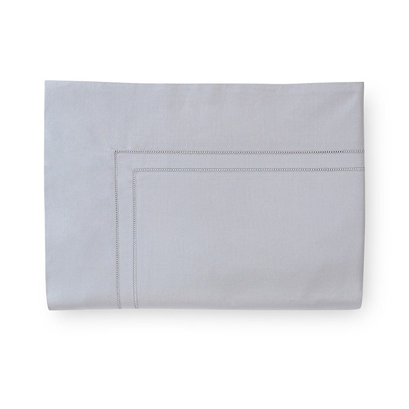 Sferra Finna flat sheet in a soft gray color featuring elegant stitched detailing along the edges.