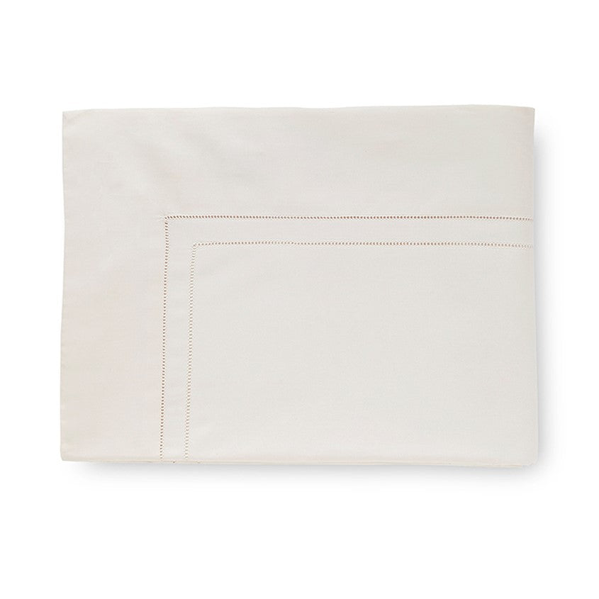 Sferra Finna flat sheet in a soft cream color with delicate stitching along the edges, showcasing elegant simplicity.