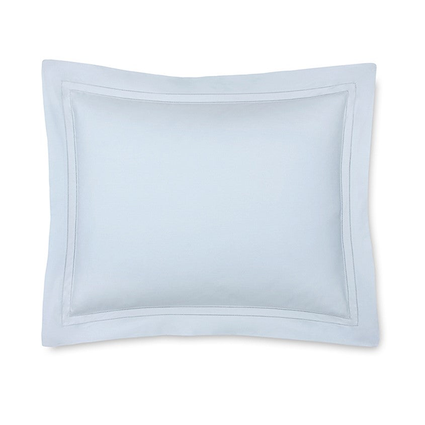 Light blue Sferra Finna pillow sham featuring a subtle border, designed for elegant bedding decor.