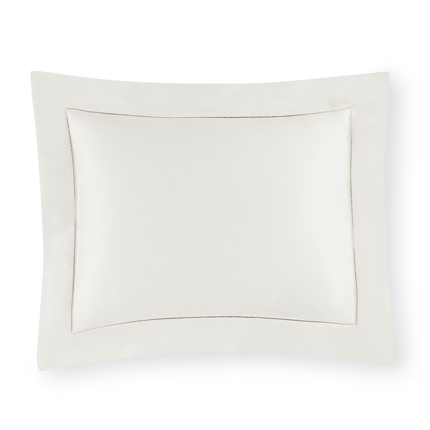 Sferra Giza 45 sateen pillow sham in soft cream with elegant piped detailing along the edges.