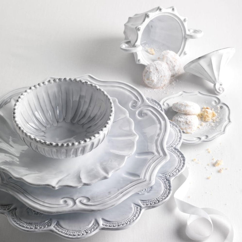 Vietri Incanto Lace European dinner plate stacked with matching bowls and dessert dishes, showcasing intricate lace detailing.